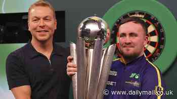 Luke Littler is handed the Sid Waddell Trophy by prostate cancer ambassador Sir Chris Hoy after beating Michael van Gerwen to win World Darts Championship