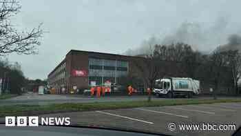 Crews fight large fire at waste management plant