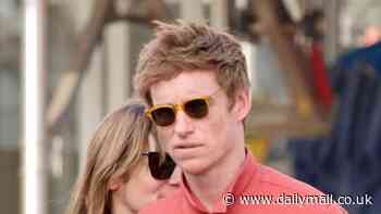 Eddie Redmayne cuts a casual figure as he walks arm-in-arm with wife Hannah Bagshawe during a shopping trip in West Hollywood