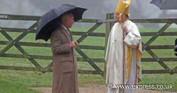 King Charles and Queen Camilla shield themselves from the rain with umbrellas in outing