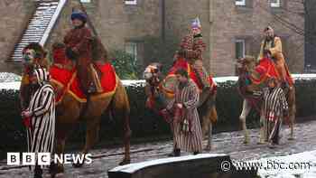 Camels led through grounds of Hereford Cathedral