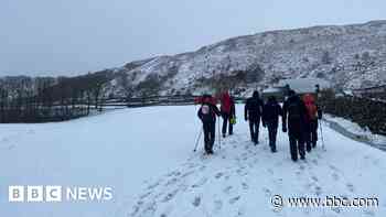 Walkers 'waist-deep in snow' rescued from mountain