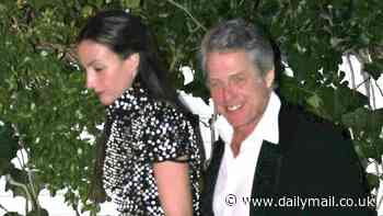 Hugh Grant flashes a cheeky smile as he departs the Golden Globes after-party with leggy wife Anna Elisabet Eberstein after earlier wowing on the red carpet