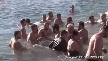 Orthodox faithful in Greece swim to retrieve the cross on Epiphany