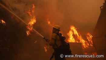 Wildfire tears into L.A. neighborhood as residents flee and jam traffic