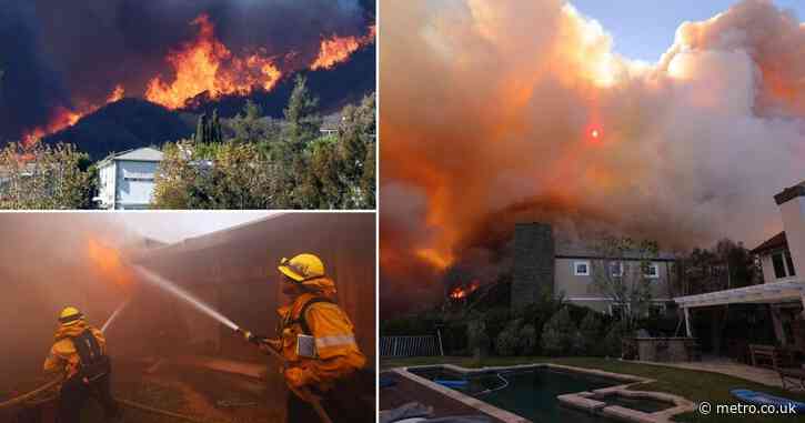 Wildfire rips through upscale coastal community as 20,000 residents evacuate