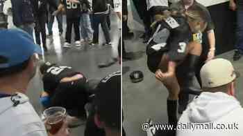 TV interview interrupted by shocking fan fight at Raiders-Chargers... as boot-wearing woman stamps on man