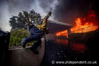 California governor says Pacific Palisades wildfire has destroyed many structures as winds kick up