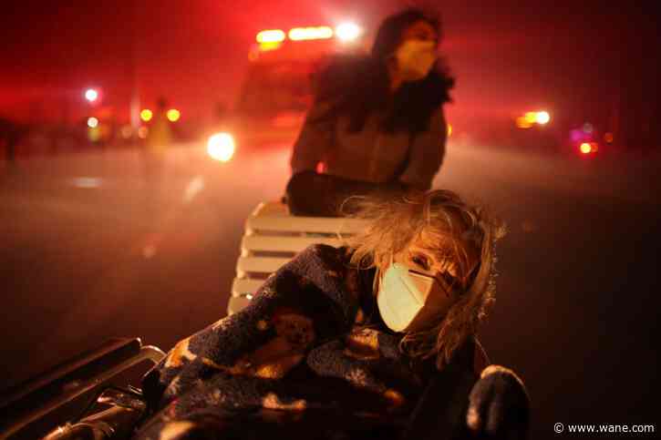 Thousands flee as wildfires burn out of control in and around Los Angeles and homes are destroyed