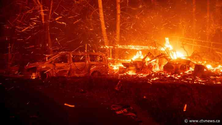 Thousands flee as wildfires burn out of control in and around Los Angeles and homes are destroyed