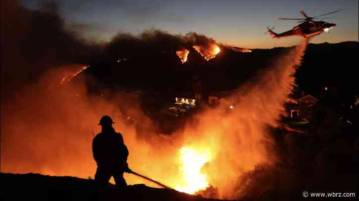 Thousands flee as wildfires burn out of control in and around Los Angeles and homes are destroyed