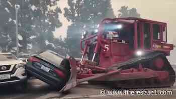 FD dozer pushes through abandoned cars as thousands flee from L.A. wildfire