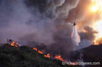 Wildfire turns scenes of L.A. into a nightmare of burning homes and fleeing residents