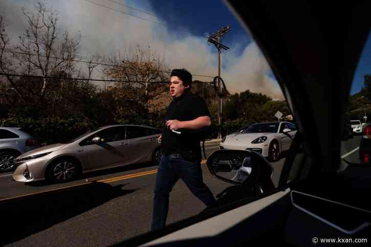 Thousands flee as wildfires burn out of control and destroy homes across the Los Angeles area