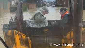 Moment heroic grandson rescues grandparents from their flooded home by carrying them in the bucket of his digger