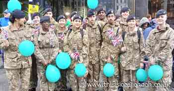 Soldiers armed with balloons march in New Year's Day parade