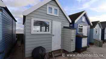 The tiny beach hut on sale for the same price as a family home: Wooden cabin in Britain's beach hut property hotspot hits the market for £450,000 -  despite having no mains electricity