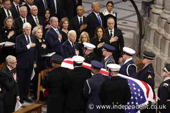 George W Bush pats Barack Obama’s belly as he takes seat at Jimmy Carter’s funeral