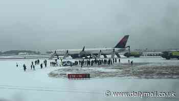 Four injured after Delta flight aborts take-off at snow-covered Atlanta airport