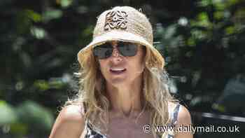 Elsa Pataky puts on a leggy display in beige mini shorts and a vest top as she walks her dogs with her daughter India, 12, on the beach in Byron Bay