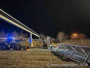 Strong winds knock down pedestrian bridge and close one of Alaska’s busiest highways