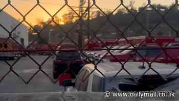 Staggering image of 100 essential fire trucks idling in a parking lot waiting for repair while Los Angeles apocalyptic fires ravage city killing 24