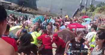 Moment 20-strong group brawl breaks out on Chile beach with one man stabbed and 4 arrested