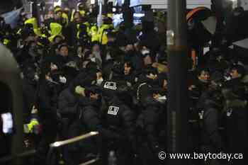 South Korean law enforcement officials enter presidential compound to detain impeached Yoon