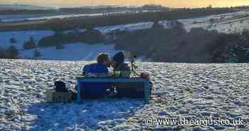 Is this you? Photographer searching for couple snapped picnicking in the snow