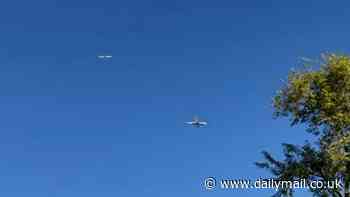 Terrifying moment two passenger jets come perilously close to a midair collision as they approach to land at Phoenix Airport before anti-crash system kicks in