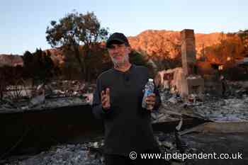 Dozens of LA residents – some armed – are defying evacuation orders to protect their homes in ‘Wild West’