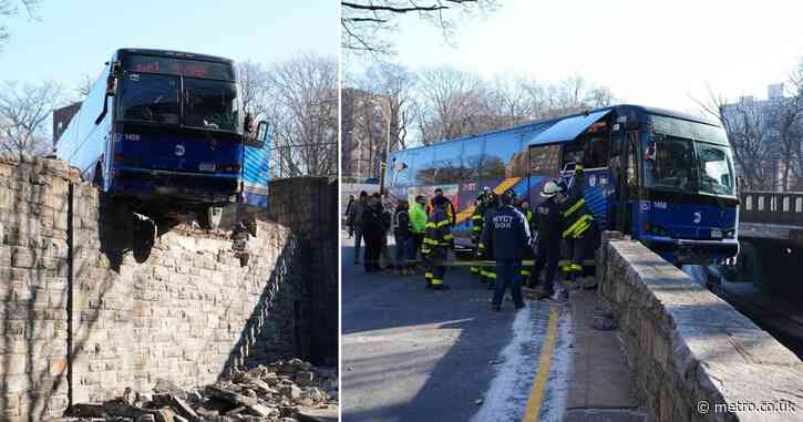 Bus smashes through guardrail and hangs over elevated roadway