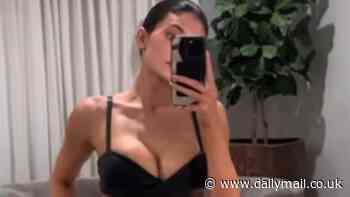 Kylie Jenner pulls down her pleather slacks to show a hint of her butt as she models a low-cut bra top