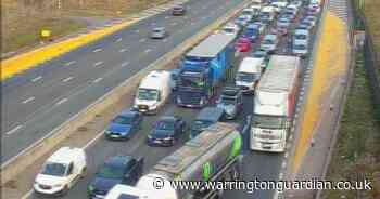 Traffic is being held on M62 in Warrington with long queues forming