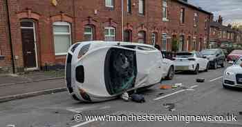 Driver hits parked cars on 'race track road' and flips vehicle in dramatic crash