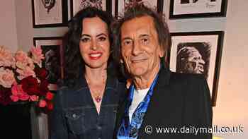 Ronnie Wood, 77, and his wife Sally, 47, look in good spirits as they cosy up at the launch of NEXUS private members' club