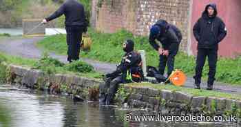 Police divers search canal after woman stabbed to death in flat