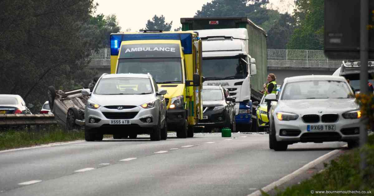 Police investigate crash that left car on its roof on A31