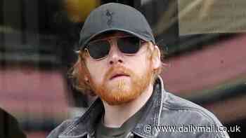 Harry Potter star Rupert Grint is every inch the doting dad as he pushes new baby Goldie in a pram during casual stroll with girlfriend Georgia Groome