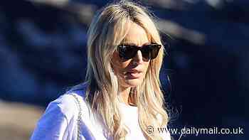 Jackie O Henderson shows off her super slender figure in baggy jeans as she steps out in Sydney with a healthy snack