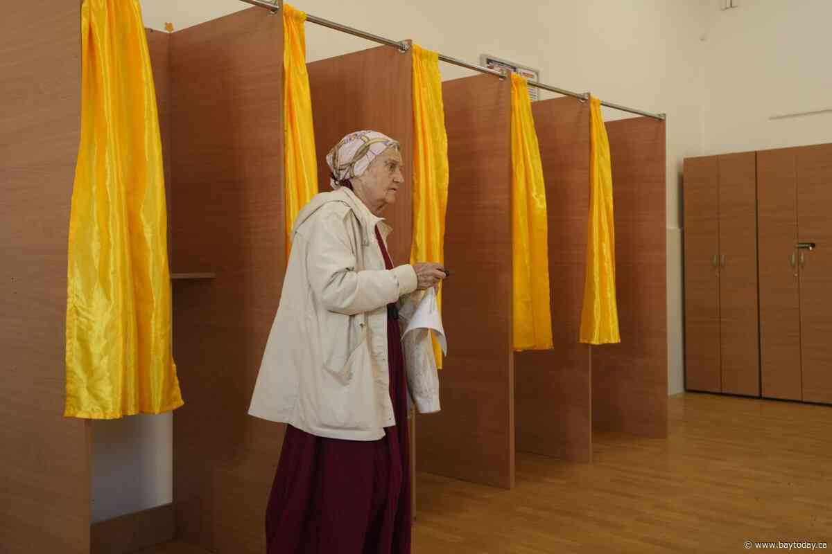 Romanians vote in a presidential redo after voided election sparked deep political crisis