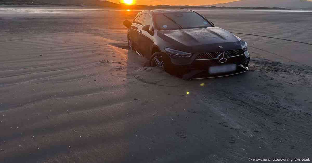 Can't park there mate! Brand new Mercedes submerged by the sea at North Wales beach
