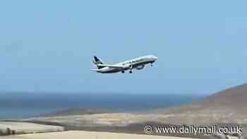 Terrifying moment Ryanair passenger jet lurches from side to side and is forced to abort its landing moments after touching down during storm in Tenerife