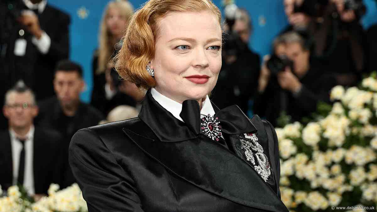 Succession star Sarah Snook looks regal in a black suit with dramatic cape as she attends the 2025 Met Gala