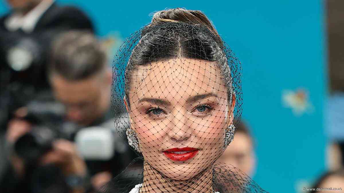 Miranda Kerr steals the spotlight in a sculptural black gown as she joins fashion's elite at the 2025 Met Gala in New York City