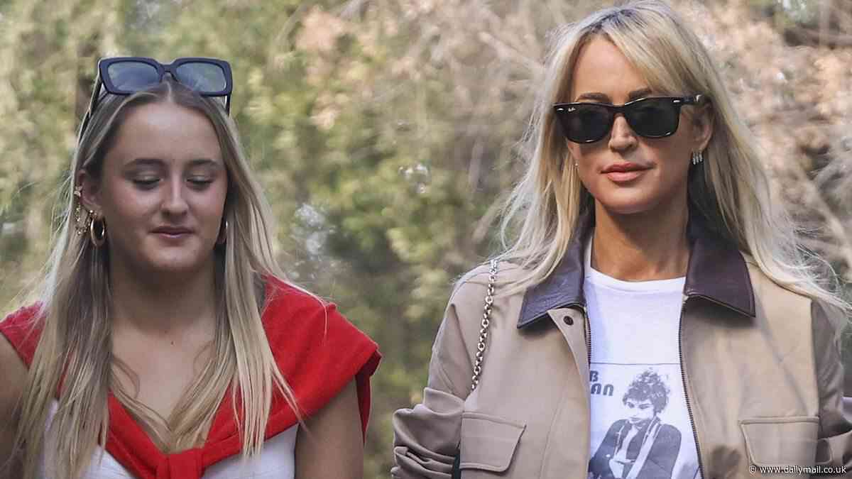 She's a cool mum! Jackie O Henderson rocks a Bob Dylan T-shirt and knee-high boots as she steps out for lunch with her teenage daughter Kitty