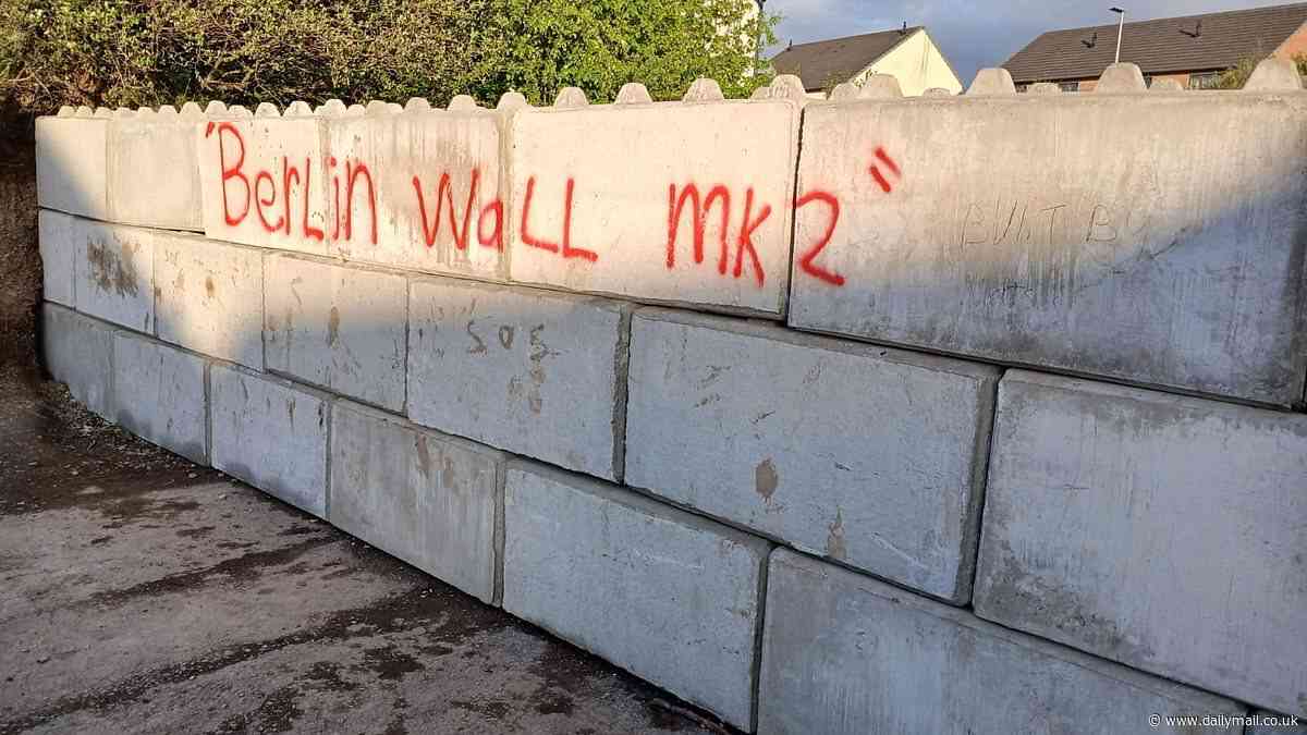 Town at war over 'Berlin Wall MK2' built to block access to a walking route after Google Maps blunder... as furious local knocks it down with a JCB
