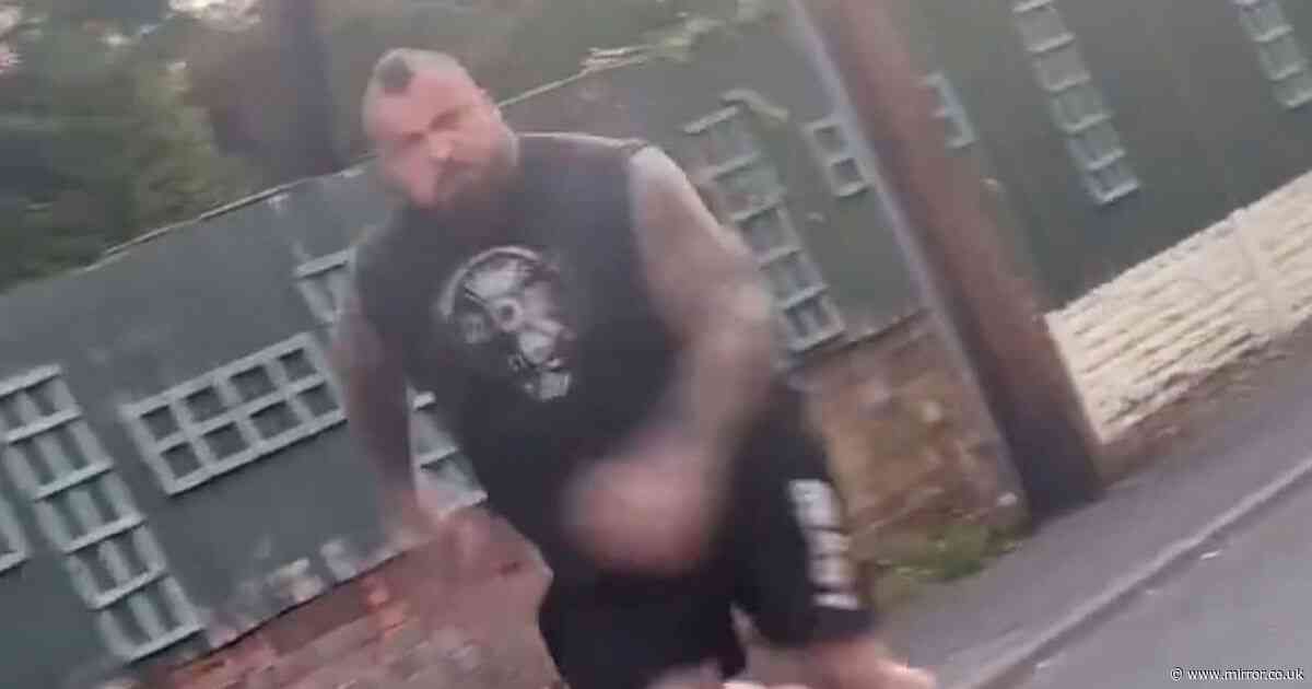 Former world's strongest man charges at car in foul-mouthed bust-up outside his home