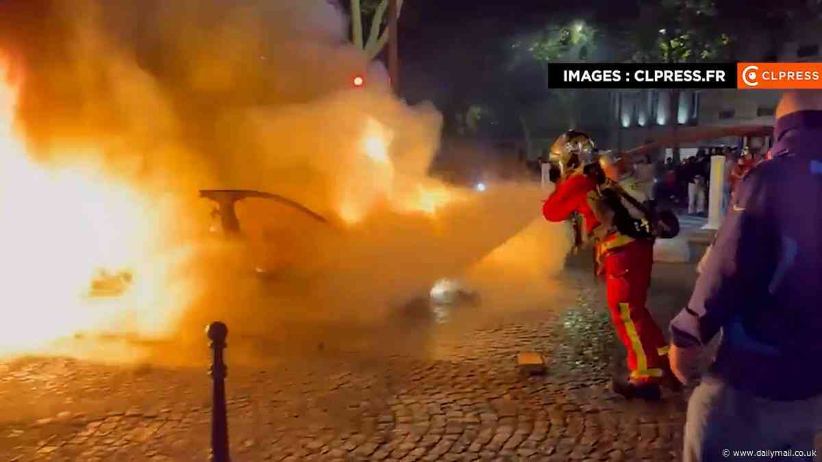 Car ploughs into crowd of football fans after PSG's victory over Arsenal as violence breaks out on the streets of Paris