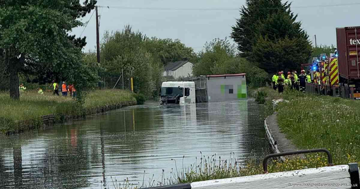 Lorry lands in CANAL after leaving the road in dramatic crash